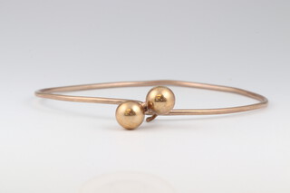 A yellow gold, testing as 9ct  bangle, 6 grams