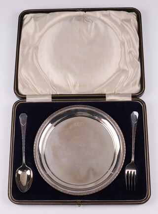 A circular silver plate Sheffield 1921 together with a matching spoon and fork Sheffield 1920 and 1922 by Lee and Wigfull, 263 grams, cased