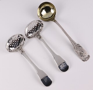 A pair of George III silver fiddle pattern ladles, London 1824, 2 silver sugar sifters and a Continental pierced silver sauce ladle, 133 grams 