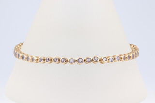 A 10ct yellow gold tennis bracelet set 47 topaz, 9.5 grams 