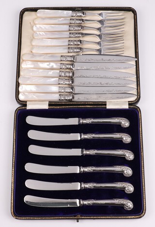 A set of 6 silver handled tea knives with embossed pistol grips together with a set of 6 silver plated fruit knives and forks with mother of pearl handles 