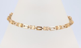 A 9ct yellow gold bracelet set 14 oval cut citrines, 19cm, 8.3 grams 