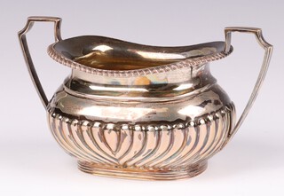 An Edwardian silver twin handed sugar bowl with demi-reeded decoration Sheffield 1906, by Lee Wigfall (Henry Wigfall), 185 grams 