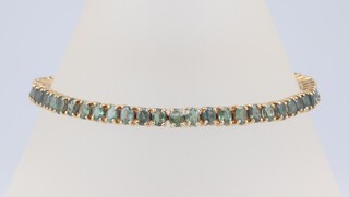 A 9ct yellow gold tennis bracelet set oval topaz, 19cm, 13.1 grams