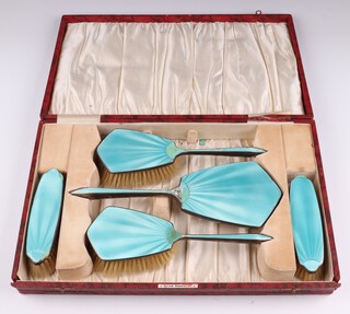 A silver and green enamelled 5 piece dressing table set comprising hand mirror, pair of hair brushes, pair of clothes brushes, Birmingham 1931, cased 