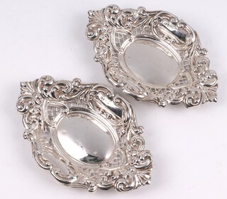 A pair of Edwardian circular embossed and pierced silver dishes, Chester 1902 by William Norton, 61 grams 