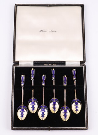A set of 6 silver gilt and enamelled coffee spoons, Birmingham 1949 by E J Trevitt & Sons, 68 grams, contained in a Harrods case 