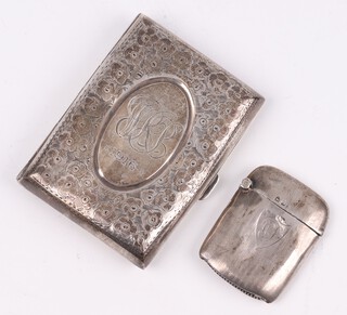 A silver cigarette case with engraved decoration Sheffield 1915,  together with a silver vesta case Birmingham 1938, both items are monogrammed and dented, 64 grams 