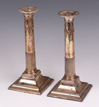 A pair of 19th Century silver plated candlesticks with detachable sconces on square bases 25cm (loose to base) 