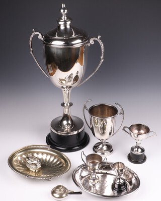 A large silver plated twin handled trophy cup and cover 55cm (split to side), 4 silver plated trophy cups, spirit burner, table lighter, entree dish and a cake basket