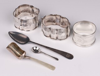 A Georgian silver Old English pattern teaspoon Newcastle, a Georgian silver caddy spoon with mother of pearl handle, silver condiment spoon, Victorian silver napkin ring and 2 white metal napkin rings, 76 grams gross 