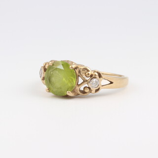 A 9ct yellow gold ring set a green stone, size N, 2.8 grams 