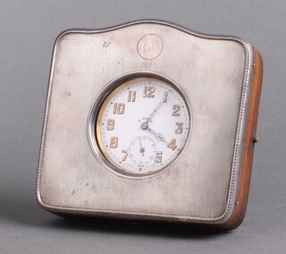 A Goliath 8 day travelling timepiece, contained in a chrome case with enamelled dial Arabic numerals within a silver mounted easel case with inscription, Birmingham 1925 