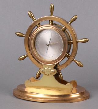 A Victorian novelty table top aneroid barometer with 7cm silvered dial in the form of a ships wheel, the base marked Baxter 16 Cockspur Street, London, 20cm x 15cm x 12cm 