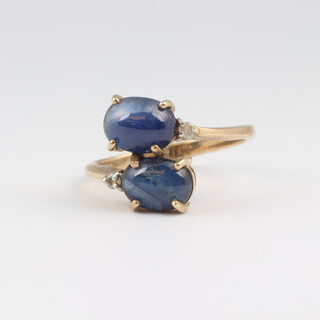 A 9ct yellow gold ring set 2 cabochon cut blue hardstones, size N, 2.9 grams