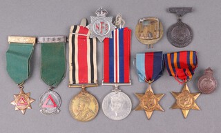 A George V issue Special Constabulary Long Service Medal to Edward Bowden, a bronze Leamington Special Constabulary medal dated 1918, a ditto lapel badge and a 1939-45 Star, Burma Star and British War medal, 2 Safe Driving medals, a National Fire Service cap badge and a drummer's badge 