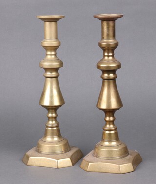 A pair of 19th Century brass candlesticks with ejectors 31cm 