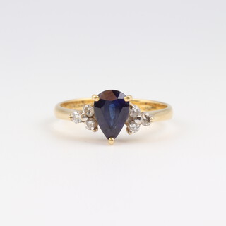 An 18ct yellow gold ring, set a pear shaped colour treated enhanced sapphire with 6 diamonds to the shoulders,  size N, 3.6 grams 