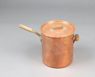 A planished copper saucepan with brass handles 23cm x 22cm 