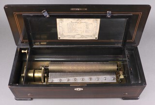 A 19th Century Swiss musical box with 33cm cylinder playing 10 aires, having original paper label to the interior of the lid, contained in an inlaid rosewood case 15cm h x 62cm w x 24cm d 