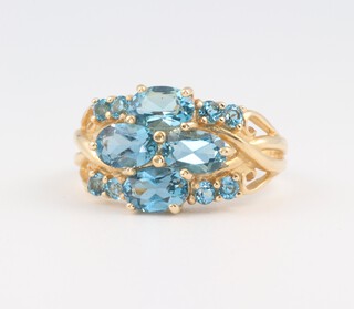 A 14ct yellow gold ring set 4 oval shaped colour enhanced and treated gem stones, 3.9 grams 