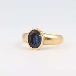 A yellow gold, testing as 18ct, ring set an oval sapphire, size P, 6 grams 