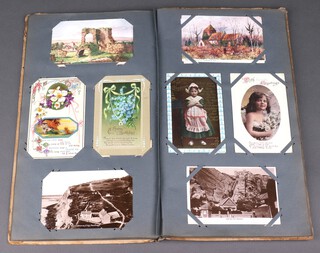 An early 20th Century postcard album complete with postcards and mainly greeting cards 