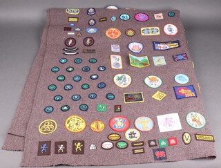 Of Girl Guide interest, a Girl Guide blanket with numerous badges, mostly from the 1980's and early 90's 105cm x 135cm 