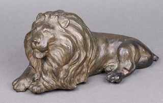 A cast bronze figure of a lion 15cm h x 32cm w