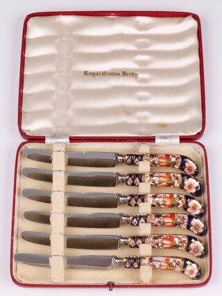 A set of 6 Royal Crown Derby tea knives with pistol grip handles cased 