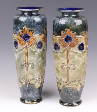 A pair of Royal Doulton blue and green salt glazed stoneware vases decorated stylised sun flowers, impressed Royal Doulton 6621 37cm  