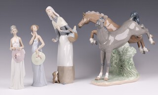 Three Lladro figures - Shepherdess with Dog 1034 27cm (finger chipped), Coquette Lady 5599 20cm and Summer Soiree 5597 20cm and a Nao figure group of 2 jumping horses 27cm 
