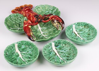A Portuguese green glazed pottery 3 section hors d'oeuvres dish in the form of lobster and leaves 25cm together with 3 matching bowls 13cm 