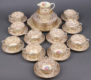 A 37 piece Royal Crown Staffordshire gilt and floral patterned tea service comprising milk jug, sugar bowl, 2 bread plates, 11 tea plates (3 cracked), 11 tea cups (6 cracked), 11 saucers 
