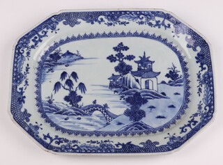 A Nanking octagonal blue and white meat plate decorated figures on a bridge by a pagoda 35cm 