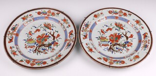 A pair of early 20th Century Japanese Imari porcelain chargers with floral decoration 35cm  