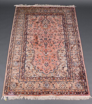 A pink and blue ground Persian rug with mihrab and mosque lantern to the centre within a 5 row border 201cm x 123cm 