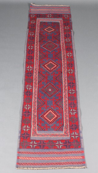 A blue and red ground Meshwani runner with 5 diamonds to the centre 236cm x 59cm 