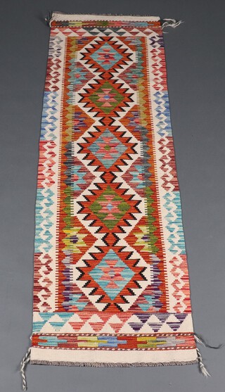 A cream, orange, green and turquoise ground Chobi Kilim runner with 5 diamonds to the centre 260cm x 60cm 