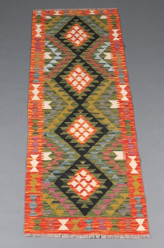 A black, brown and green ground Maimana Kilim runner with 4 diamonds to the centre 108cm x 68cm 
