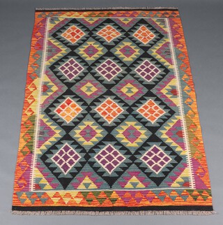 A green, black and orange ground Maimana Kilim rug with all over diamond design 188cm x 120cm 