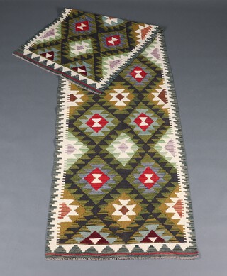 A white, green and black ground Maimana Kilim runner with overall diamond design 293cm x 82cm 