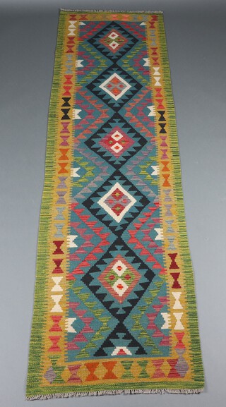 A green, black and brown ground Maimana Kilim runner with 5 diamonds to the centre 297cm x 83cm 
