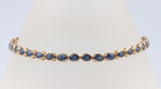A 10ct gold sapphire set tennis bracelet, 20cm, 10.13 grams 