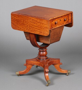 A Victorian mahogany drop flap work table fitted a drawer and deep basket, raised on a U shaped support with triform base, splayed feet, brass caps and casters 71cm h x 50cm w x 38cm d 
