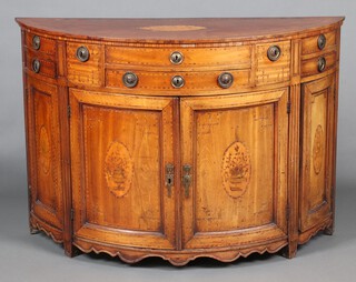 A Dutch 18th Century inlaid demi-lune side cabinet, the top inlaid a shell fitted 2 long drawers flanked by 2 short drawers and 4 short quarter drawers, the base fitted 3 cupboards enclosed by inlaid panelled doors, raised on square tapered supports 88cm h x 130cm w x 48cm d  