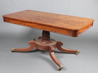 A William IV rectangular mahogany pedestal library table, raised on turned column with splayed feet, brass caps and casters 69cm h x 154cm w x 76cm d  