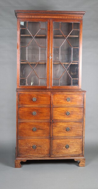 A 19th Century mahogany bookcase on cabinet, the upper section with Grecian key pattern cornice, fitted shelves enclosed by astragal glazed panelled doors, the base fitted a cupboard enclosed by panelled doors in the form of 8 short drawers 210cm h x 194cm w x 48cm d 