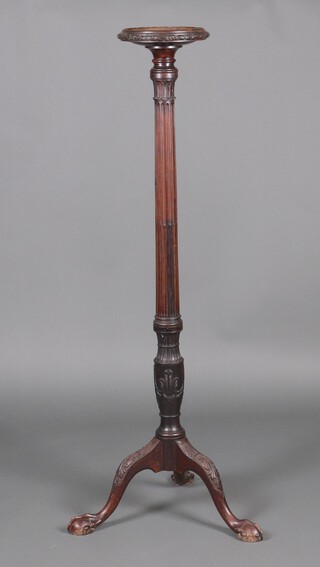 An Edwardian Georgian style mahogany torchere, raised on turned and fluted column with tripod base and egg and claw supports 46cm h x 25cm diam. 