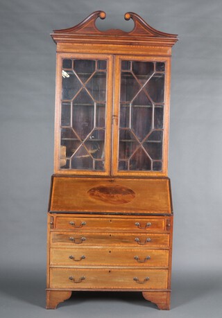 An Edwardian inlaid mahogany bureau bookcase with broken pediment, fitted adjustable shelves enclosed by astragal glazed panelled doors, the base with fall front above 4 long drawers, raised on bracket feet 226cm h x 90cm w x 46cm d 